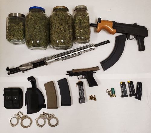 Jars of Marijuana-Automatic Gun-Gun Barrel-Handgun-Handcuffs-Bullets